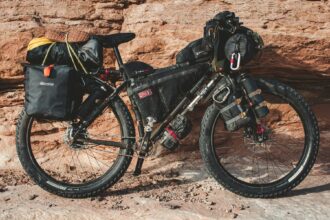 Fat bike with frame bag and panniers against red rock