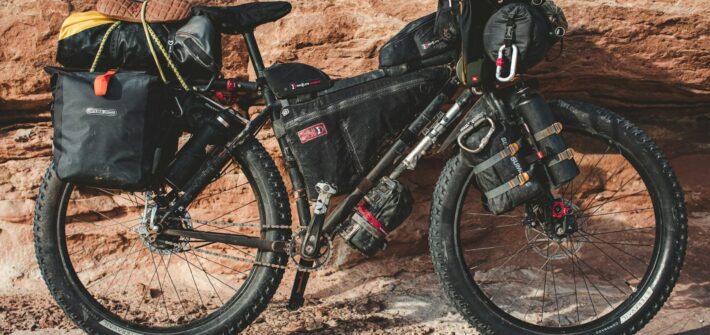 Fat bike with frame bag and panniers against red rock