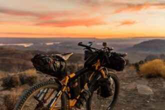 Loaded bike on a ridge at sunset