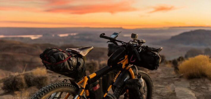 Loaded bike on a ridge at sunset