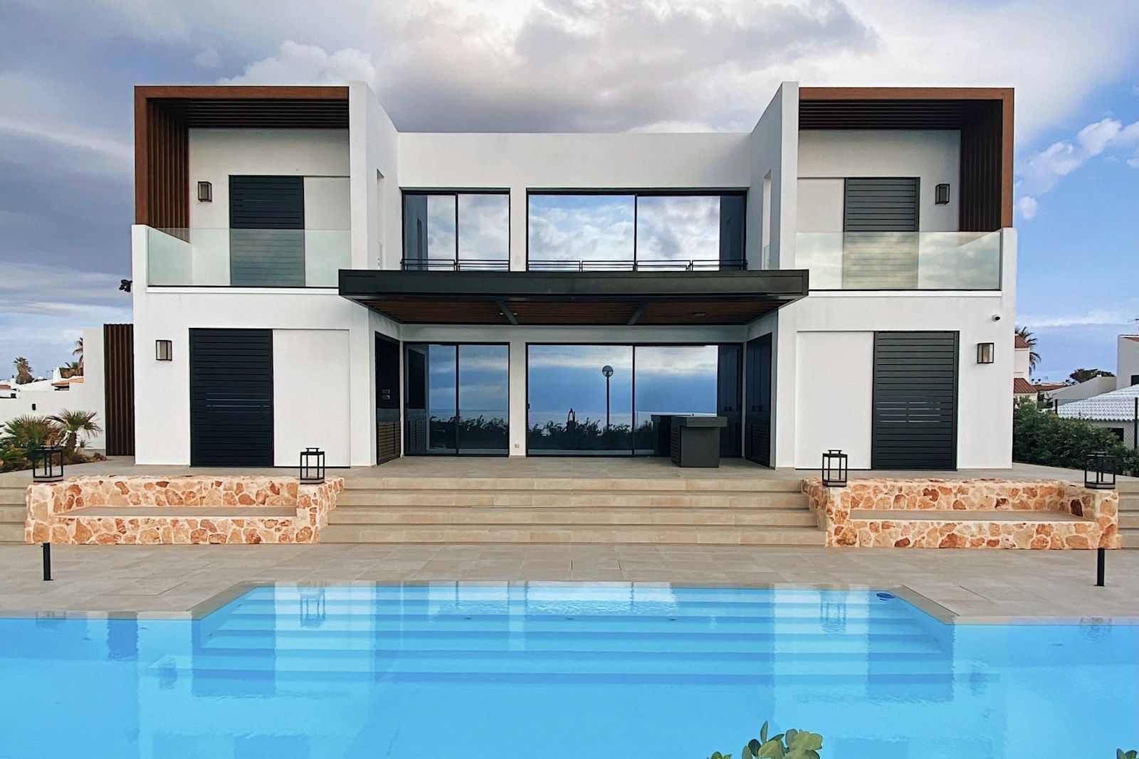 A terrace that steps down to the pool