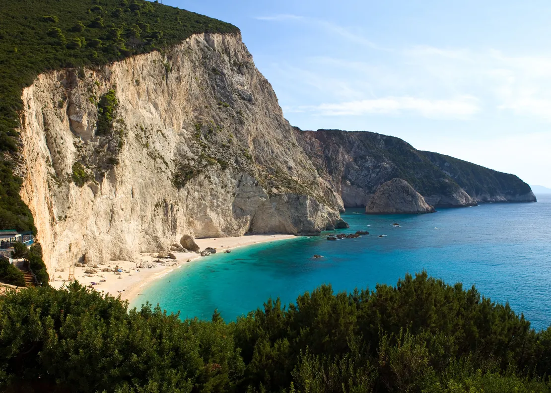 White cliffs above Porto Katsiki beach on Lefkada, the sea bright turquoise below and pine scrub in the foreground