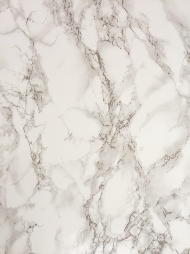 Close-up of a white marble slab with fine grey veining