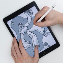 Hand sketching an illustration on a tablet with a stylus