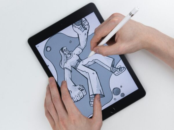 Hand sketching an illustration on a tablet with a stylus