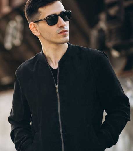 A man wearing black jacket with black sunglass