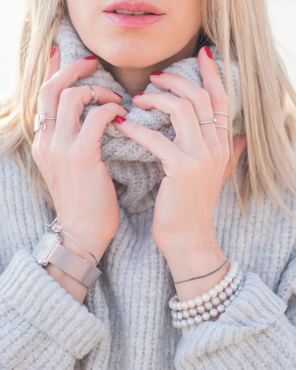 A woman in a soft grey rollneck sweater