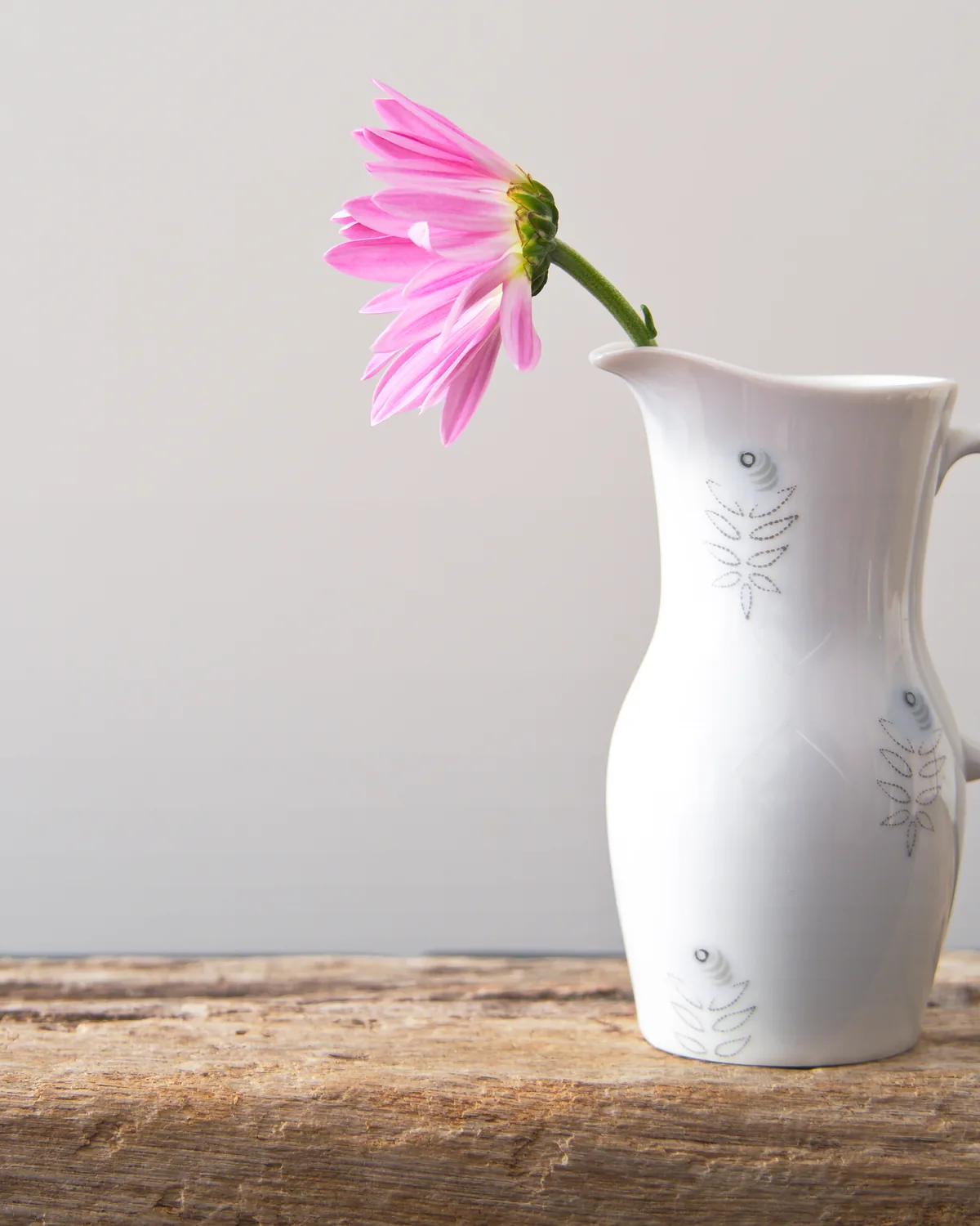 A white ceramic jug on a timber table