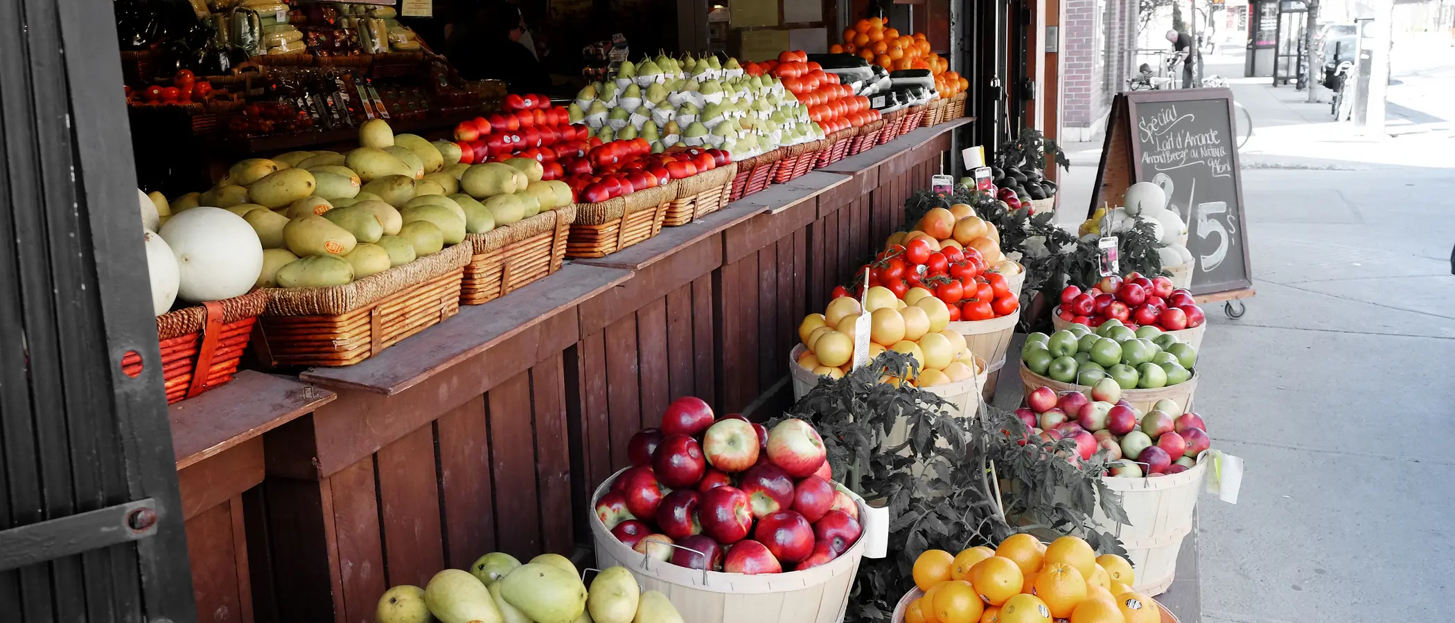 A greengrocer's shopfront with crates lining the pavement