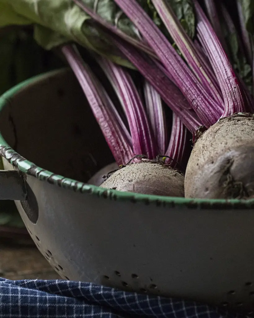 Beetroot with leafy tops in an enamel pot