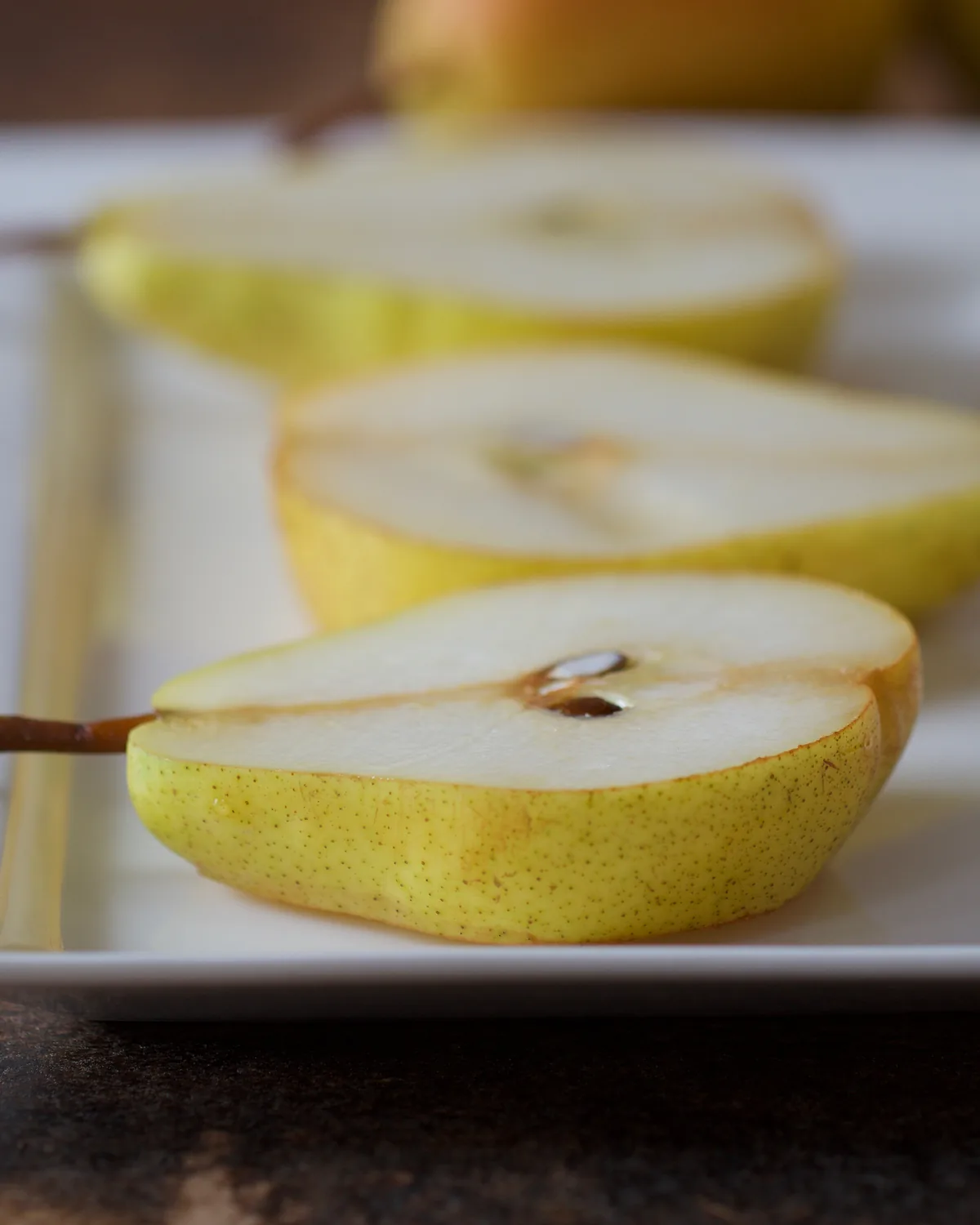 Slices of pear fanned on a white plate