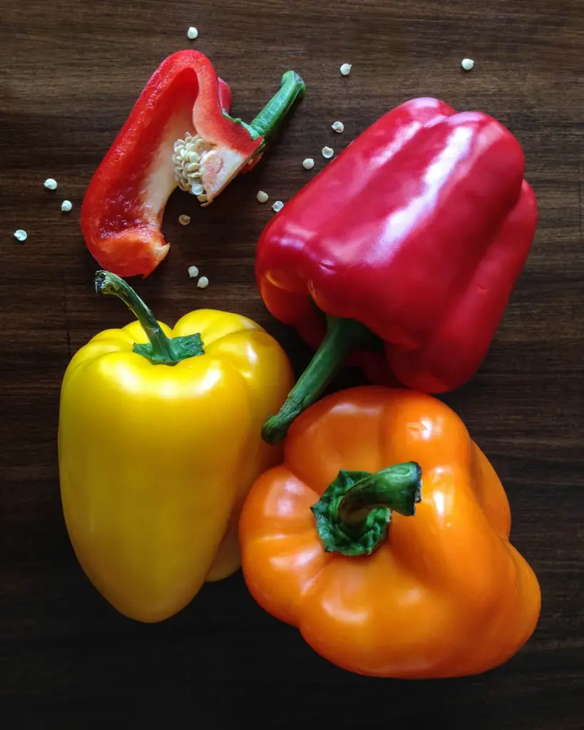 Three bell peppers, red, yellow and orange