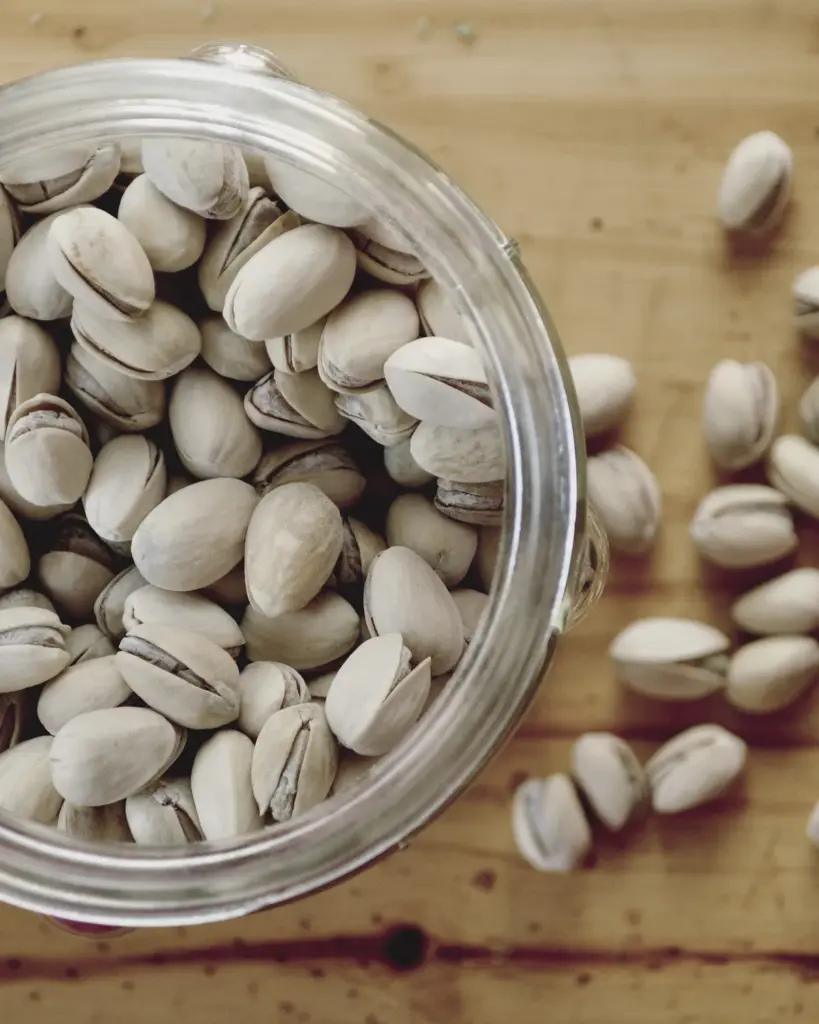 A glass bowl of pistachios