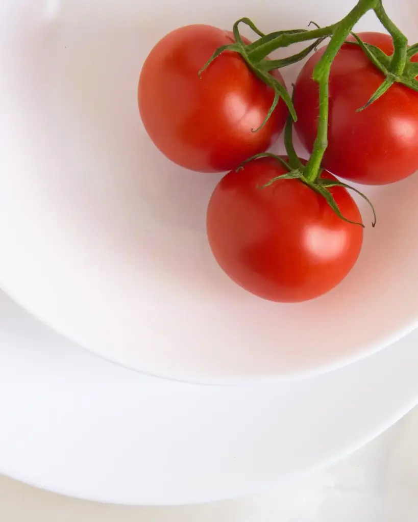 Tomatoes on the vine in a white bowl