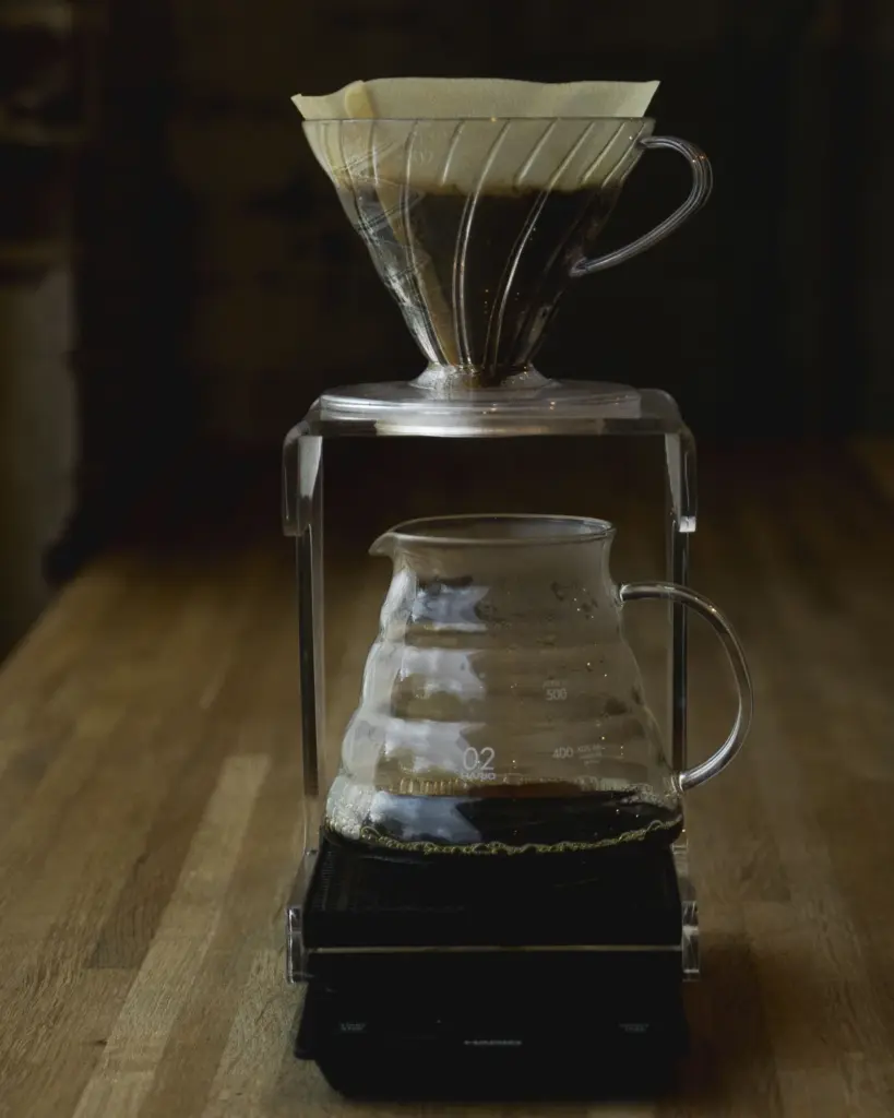 A glass pour-over carafe and cone standing on a brew scale