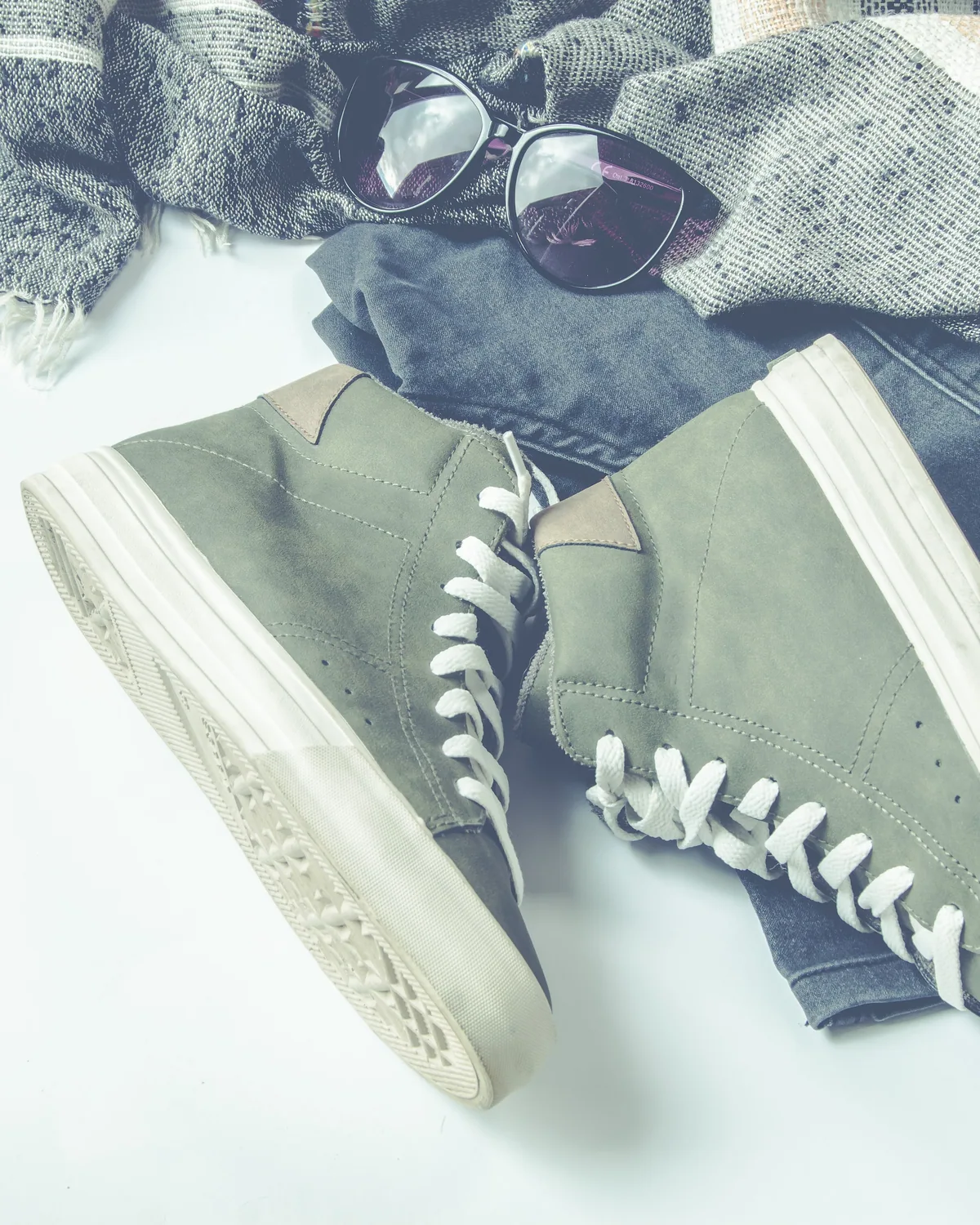 Sage-grey canvas high-tops with white laces, laid flat