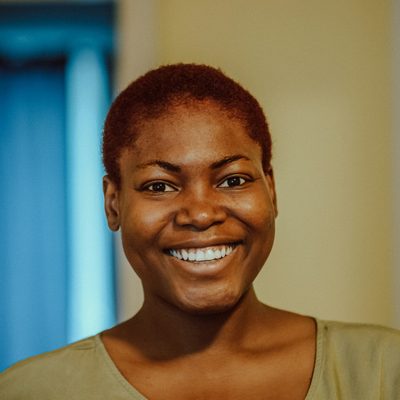Grace Okonjo, who leads families and children's work, smiling in warm afternoon light
