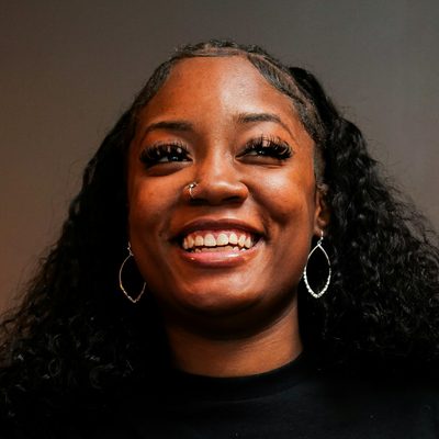 Amara Nwosu, head of platform at Verity, laughing in a studio portrait