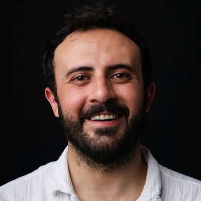 Ben Marchetti, CTO of Pier & Post, in a white shirt against a dark studio backdrop