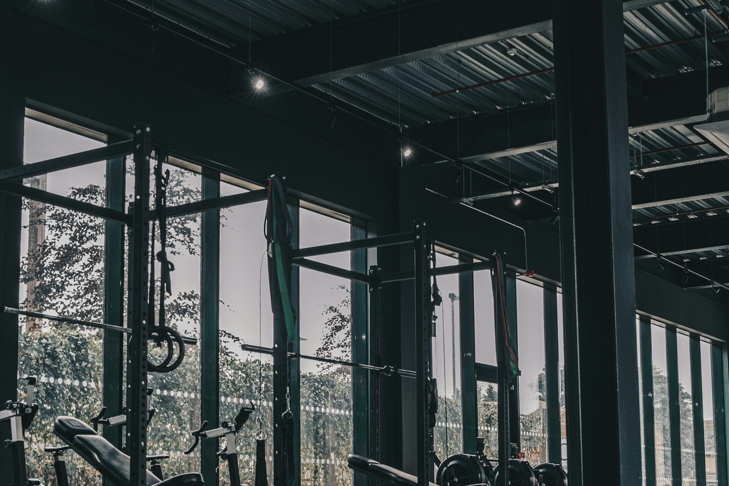 A row of racks along the window wall of the Ironworks training room, with daylight coming in and not a mirror anywhere